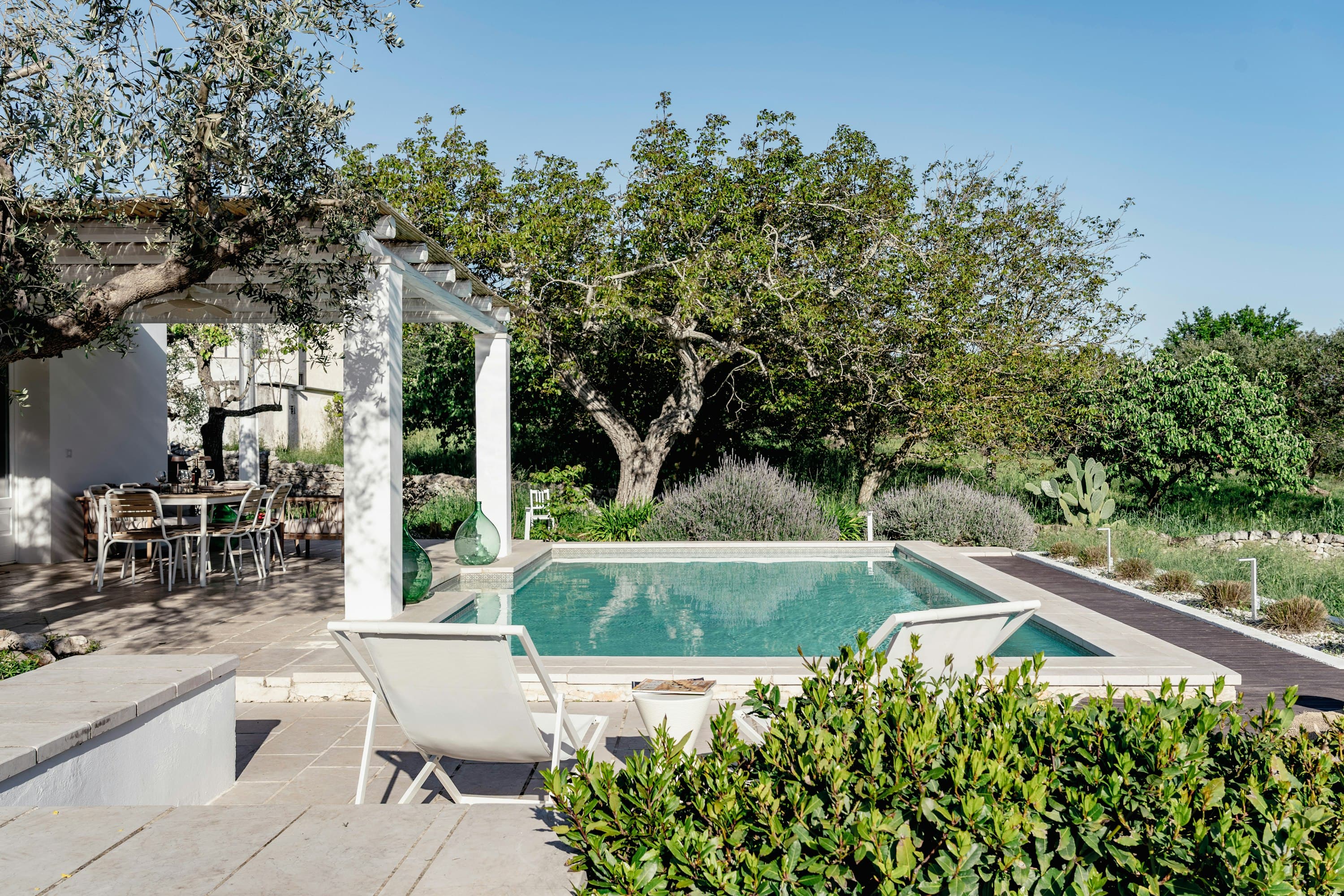 Itria Birdsong trullo exterior with conical roofs and cobblestone courtyard, Martina Franca, Puglia, Italy