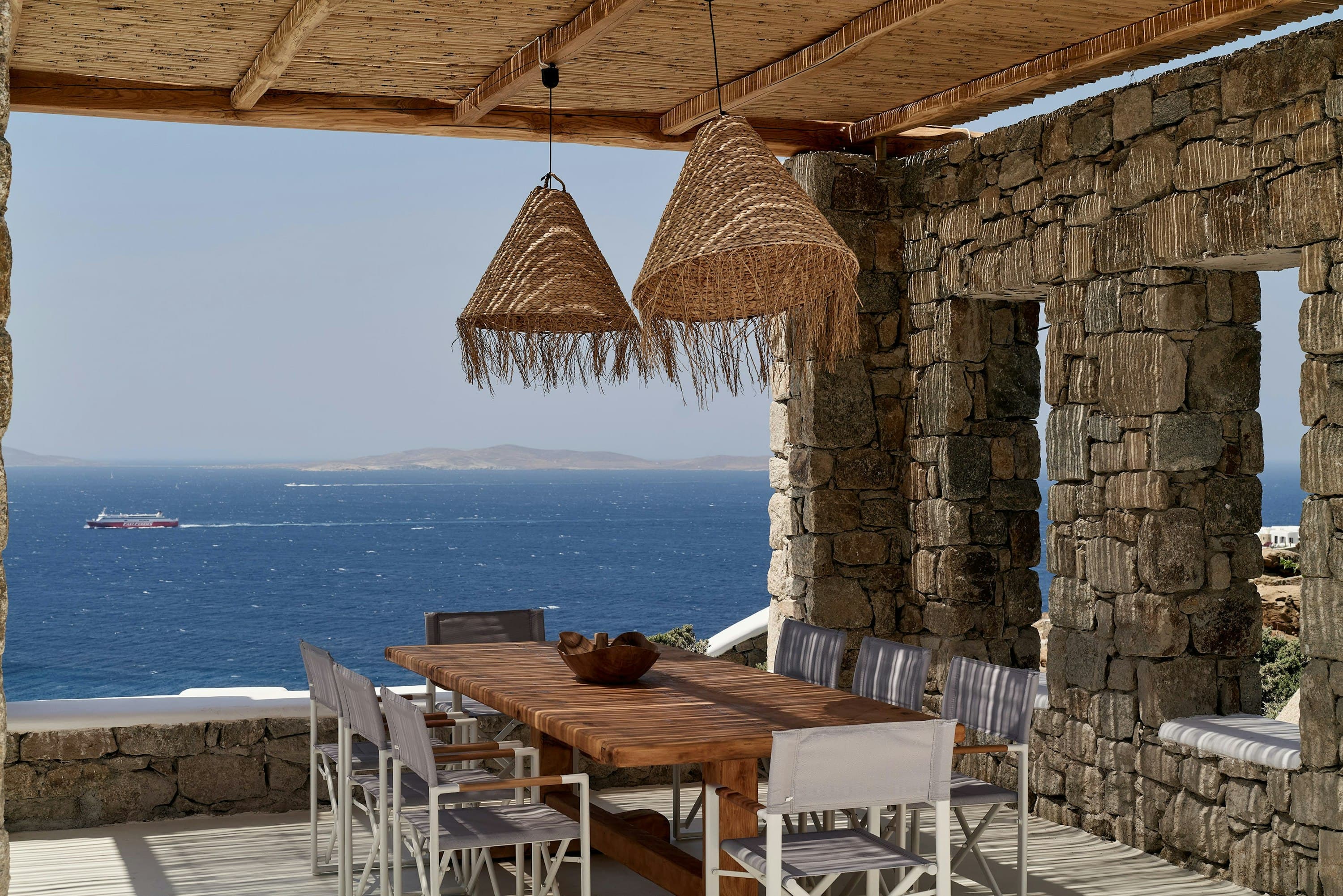 Bohemian Bay Retreat outdoor dining terrace with sea views, Mykonos, Cyclades Islands, Greece