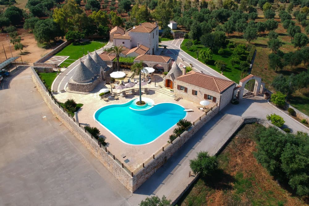 Sublimia villa aerial view with turquoise pool and olive groves, Ceglie Messapica, Apulia, Italy