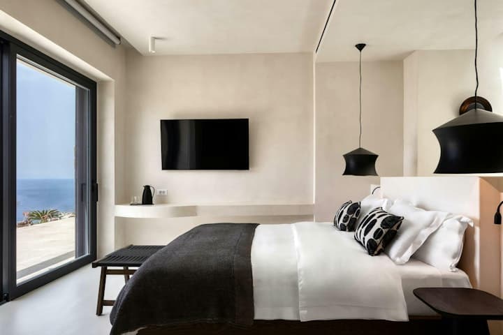 Heavenly Joy villa master bedroom with ocean views and white linens, Mykonos, Greece