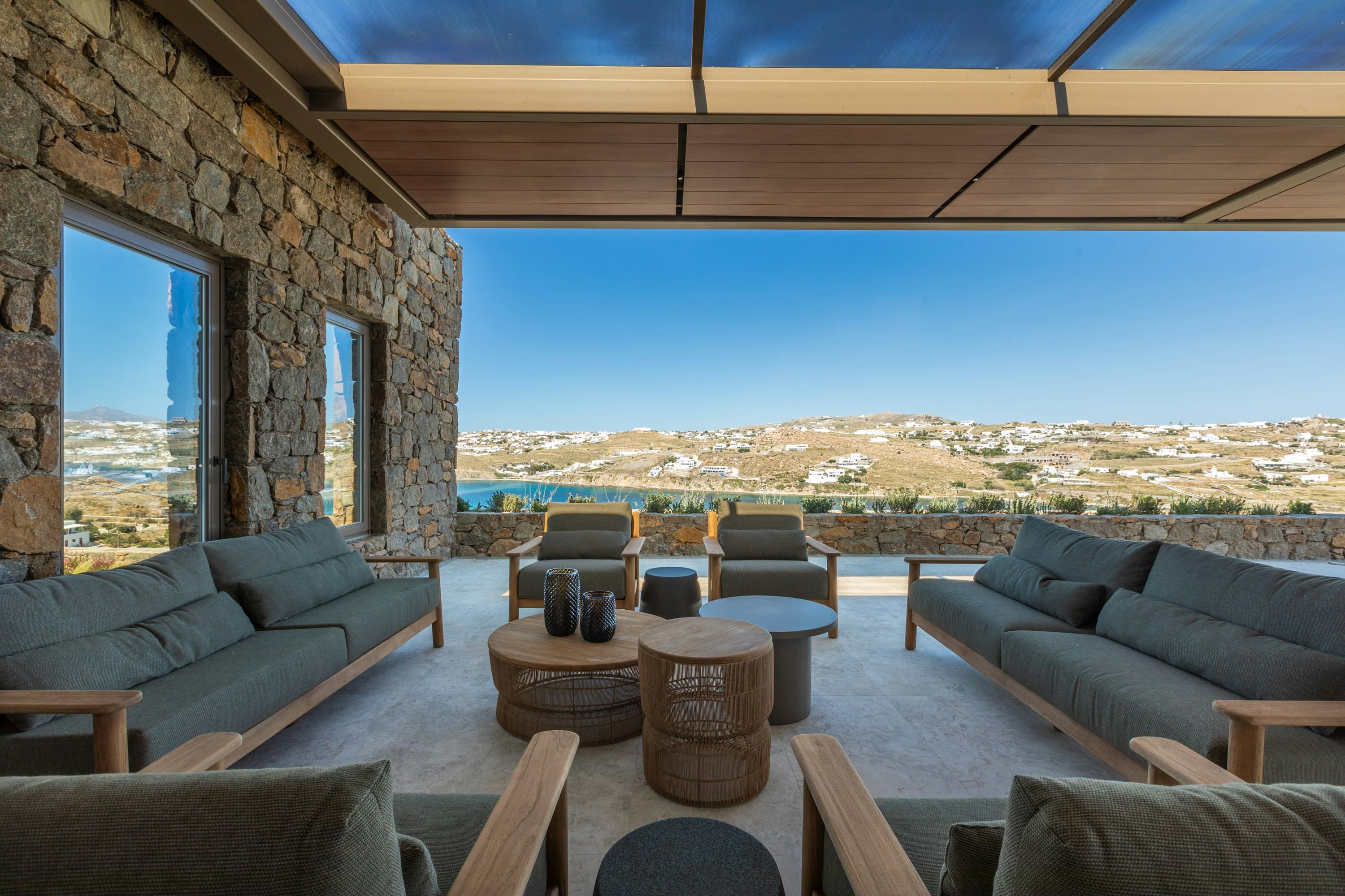 Aegean Aspect covered terrace with traditional stone walls and sea views, Ornos, Greece