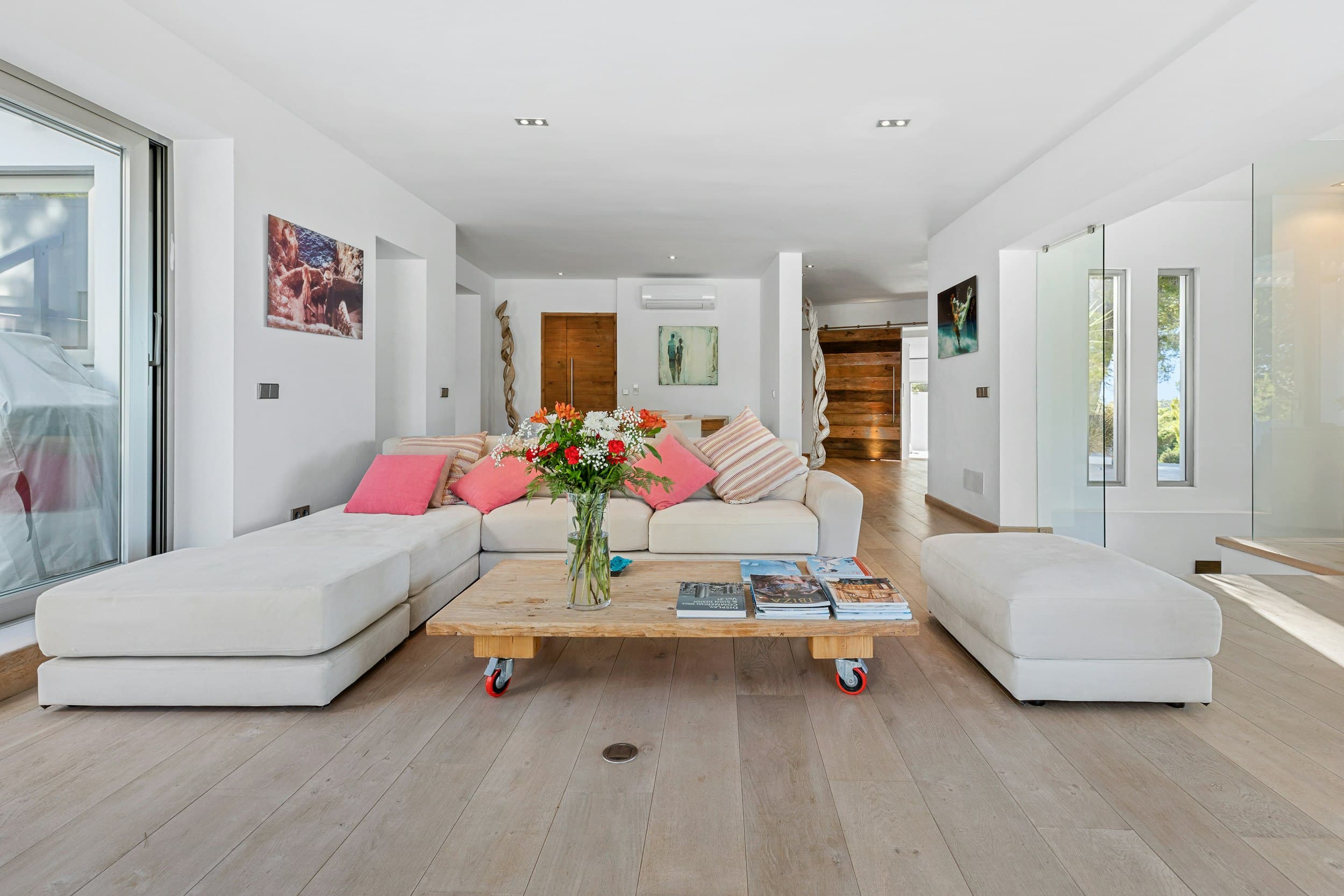 The Balearic Beat living room with white sofa and rustic table, Sant Josep de sa Talaia, Spain