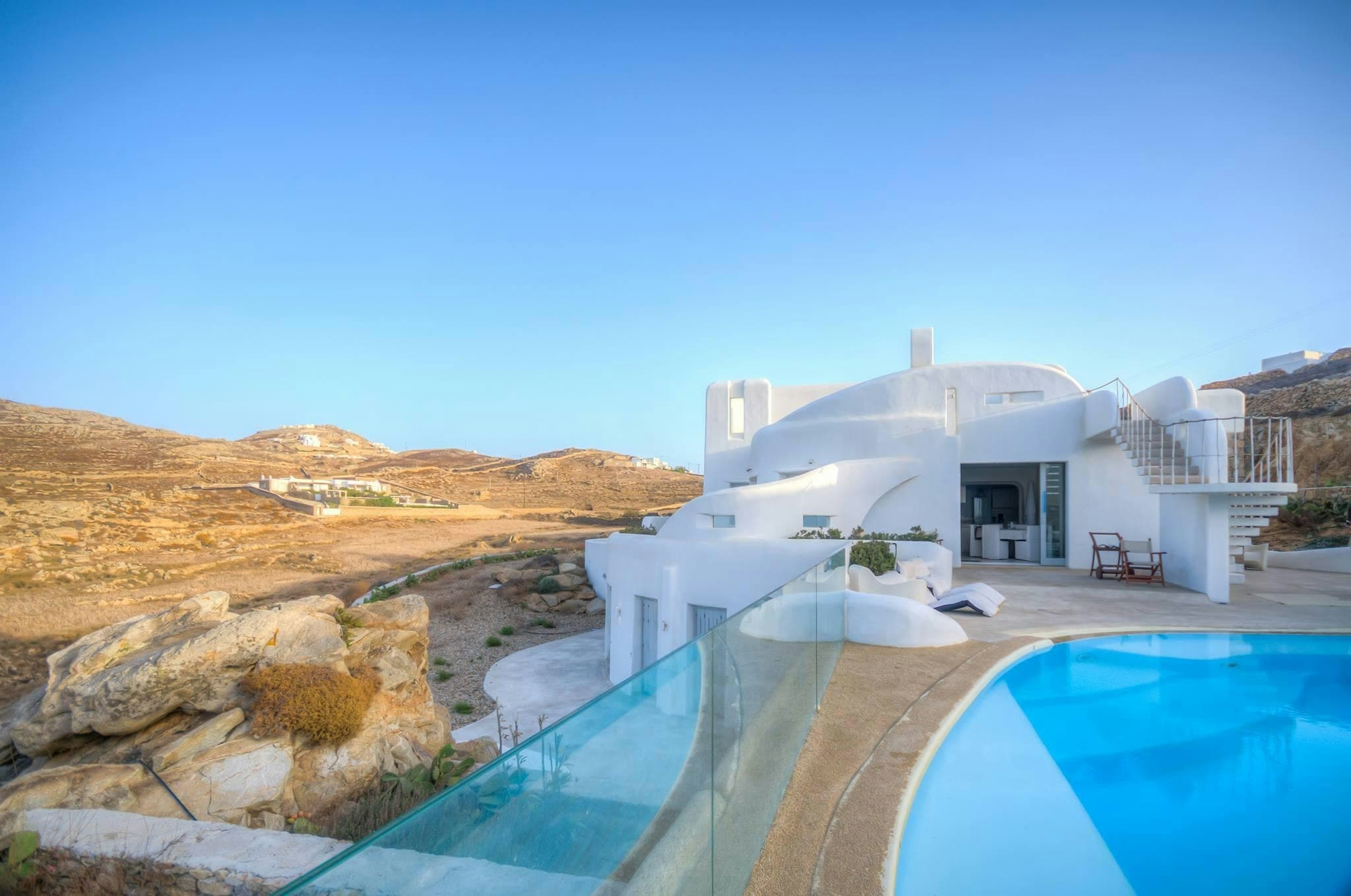Light On The Aegean villa exterior with cascading infinity pools overlooking Aegean Sea, Mykonos, Greece