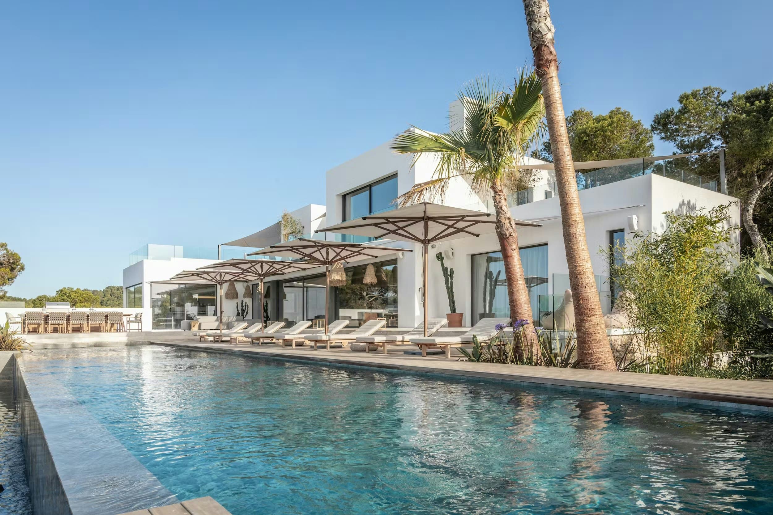 Sunburst Eleganza villa exterior with infinity pool and palms, Talamanca, Balearic Islands, Spain