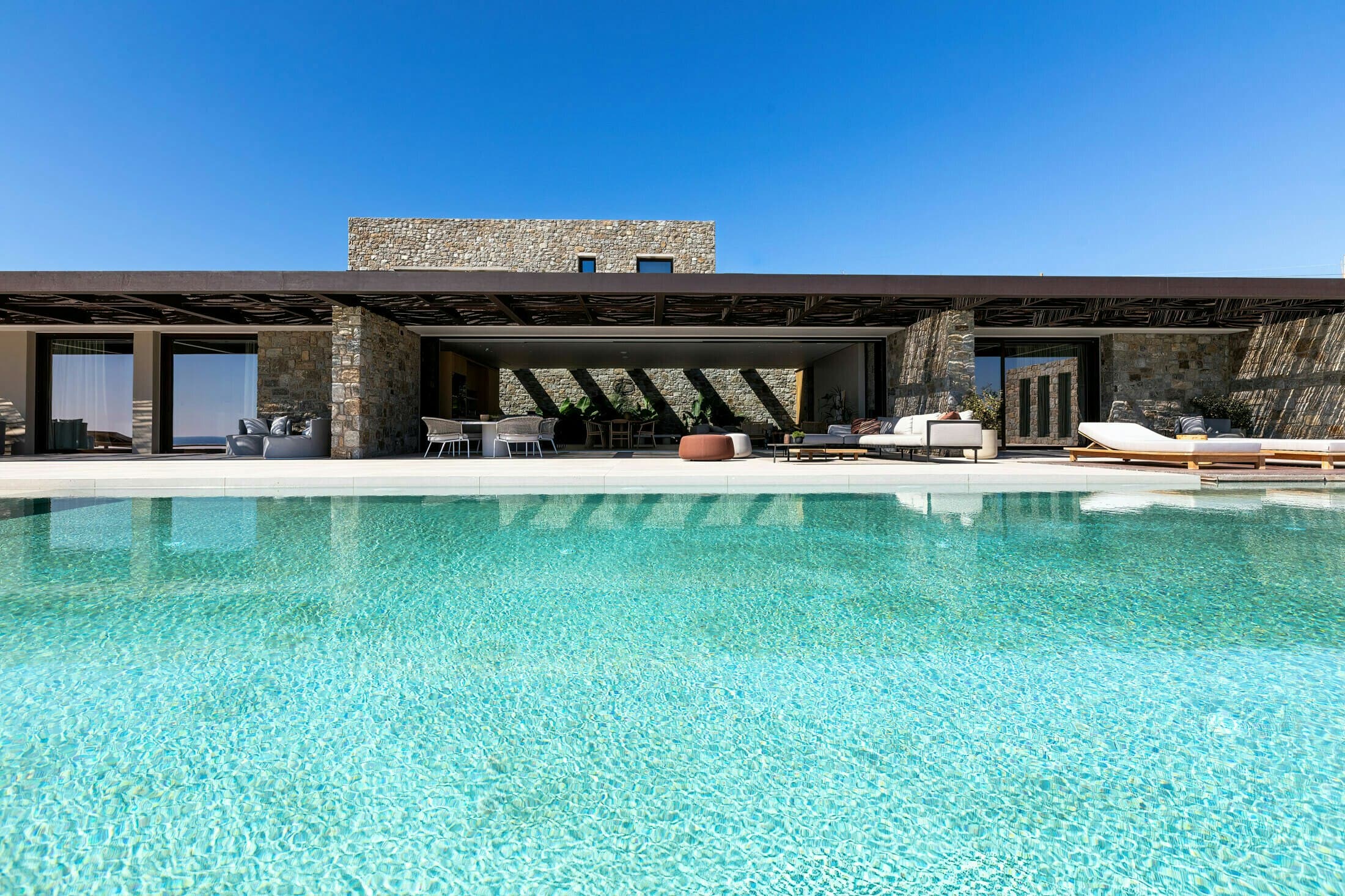 Ocean Breeze & Sea Views villa exterior with infinity pool overlooking the Aegean Sea, Mykonos, Greece