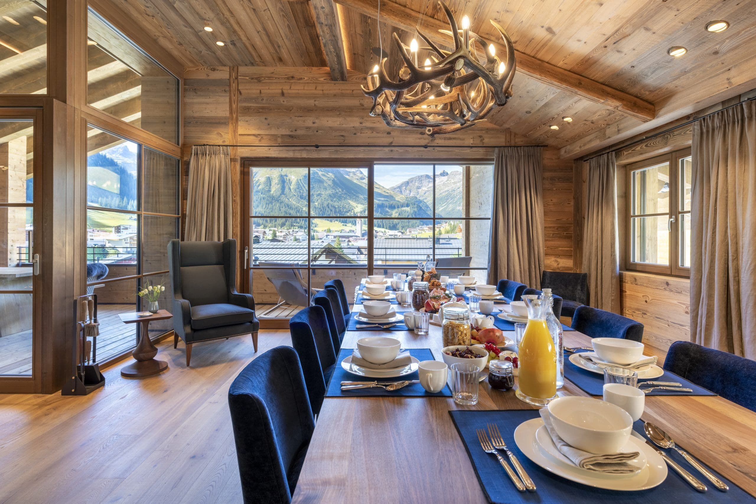 Chalech S formal dining area with antler chandelier and mountain panoramas, Lech, Austrian Alps, Austria