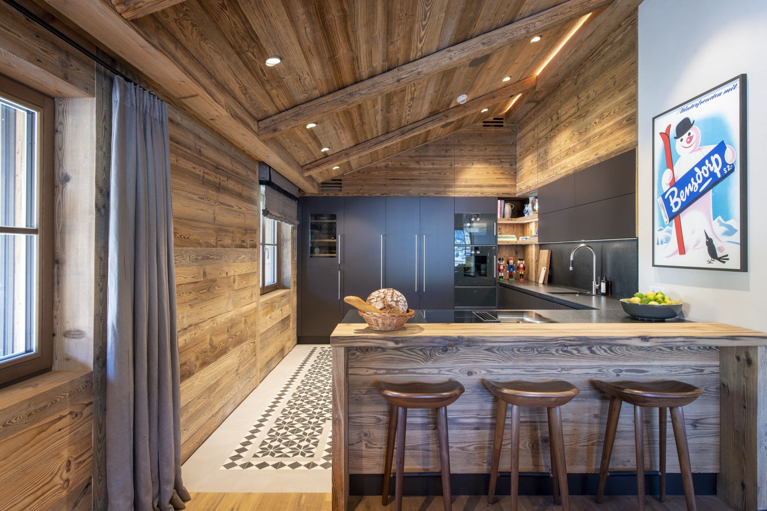 Chalech S modern kitchen with matte black cabinets and natural wood island, Lech, Austria