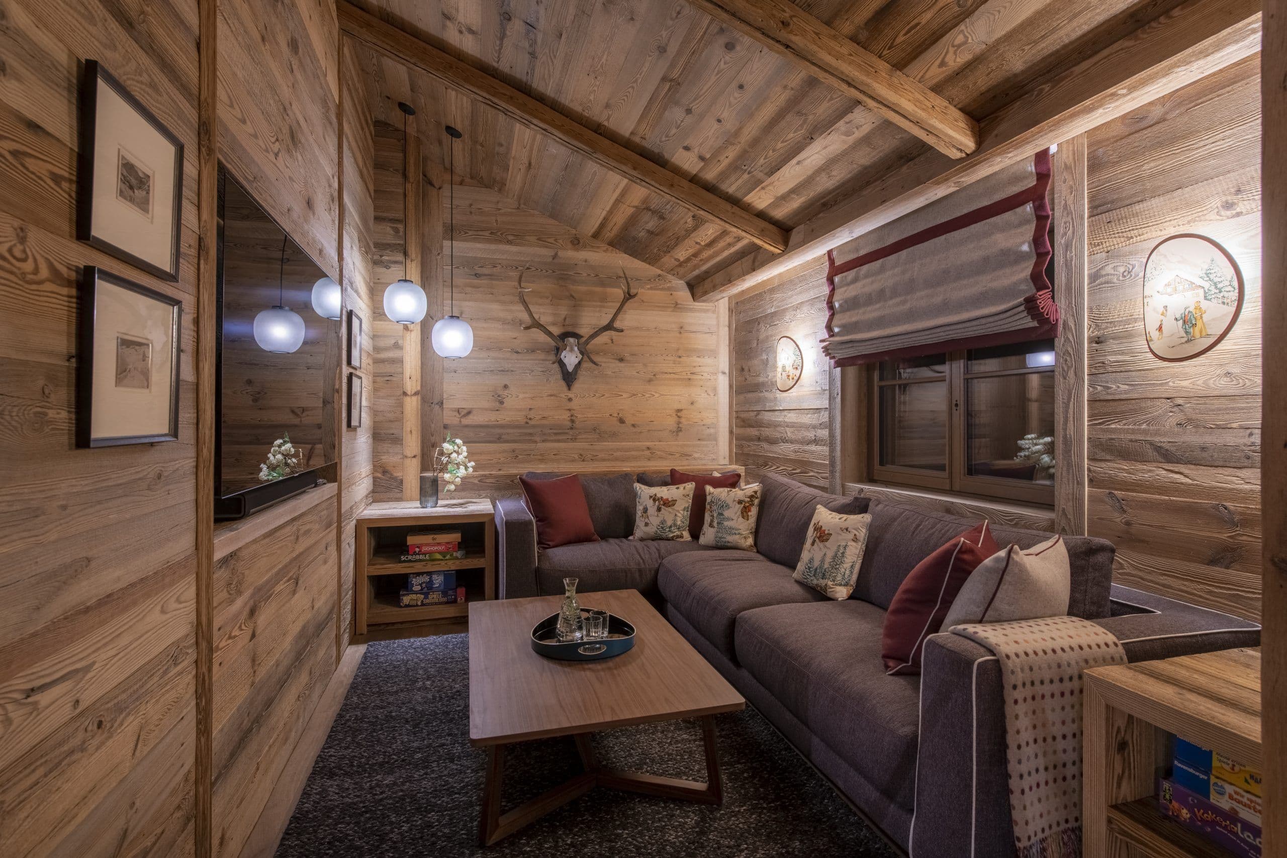 Chalech S traditional media room with natural wood walls and Alpine details, Lech, Austria