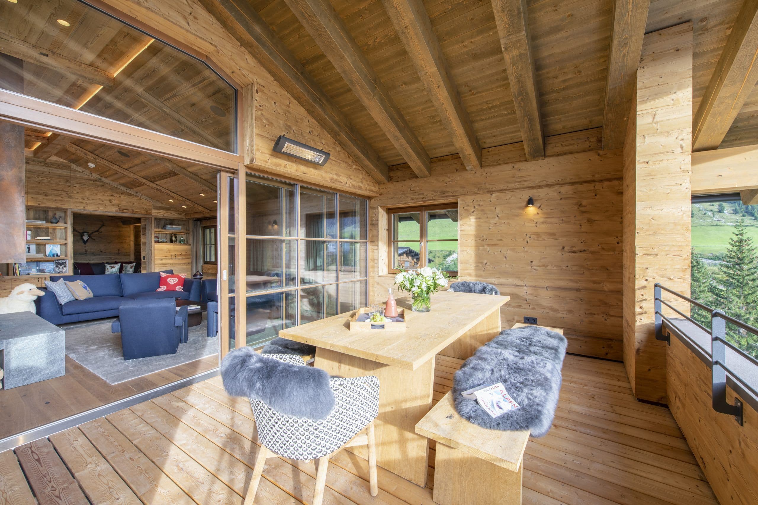 Chalech S covered balcony terrace with rustic wood details and valley views, Lech, Austria