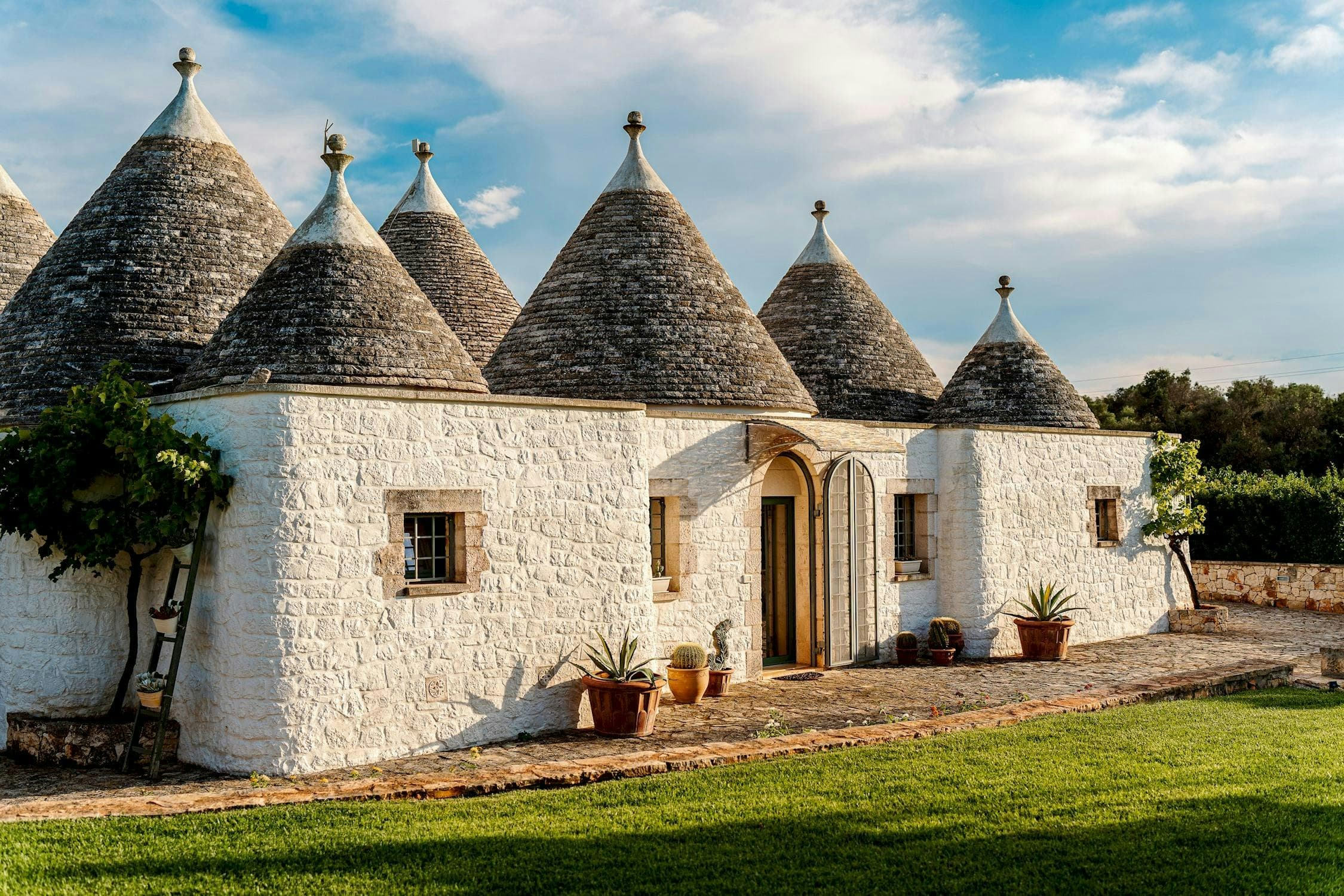 White Village Escape traditional trullo exterior with conical roofs, Ostuni, Puglia, Italy