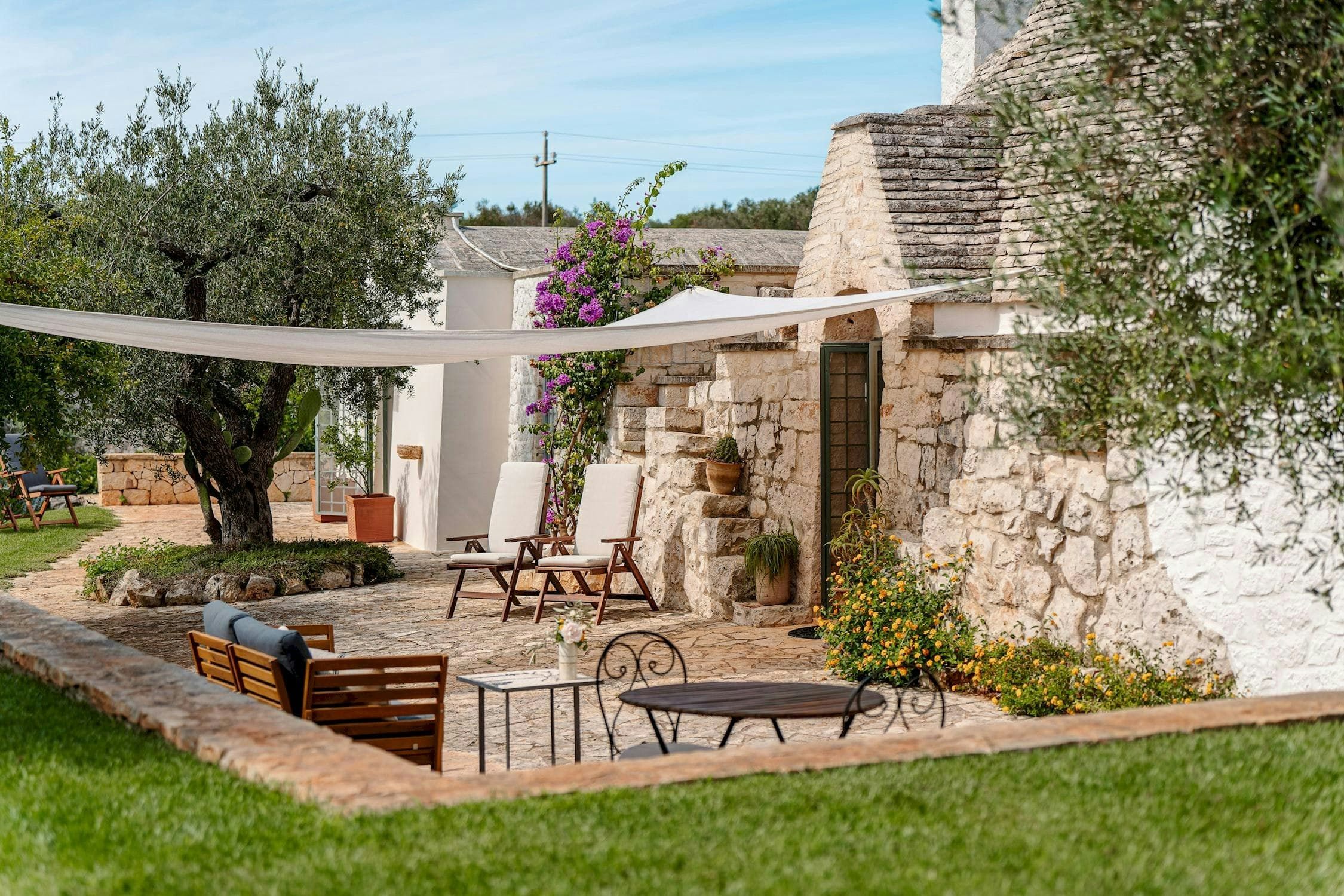 White Village Escape outdoor lounge terrace with trullo architecture, Ostuni, Puglia, Italy