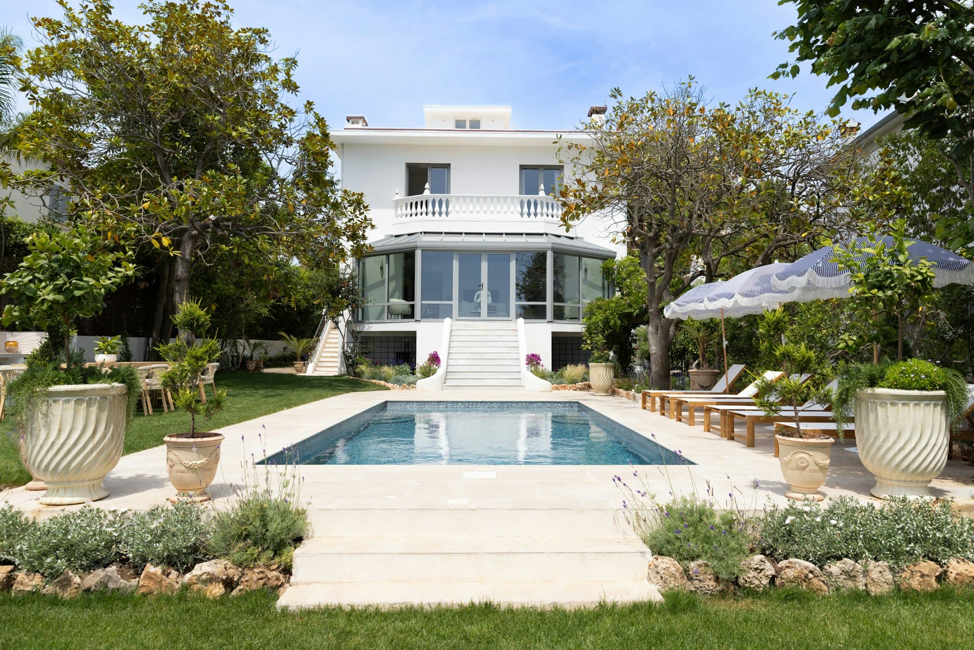 Côte D'Azur Sunshine villa exterior with pool and classical balustrade balcony, Antibes, France