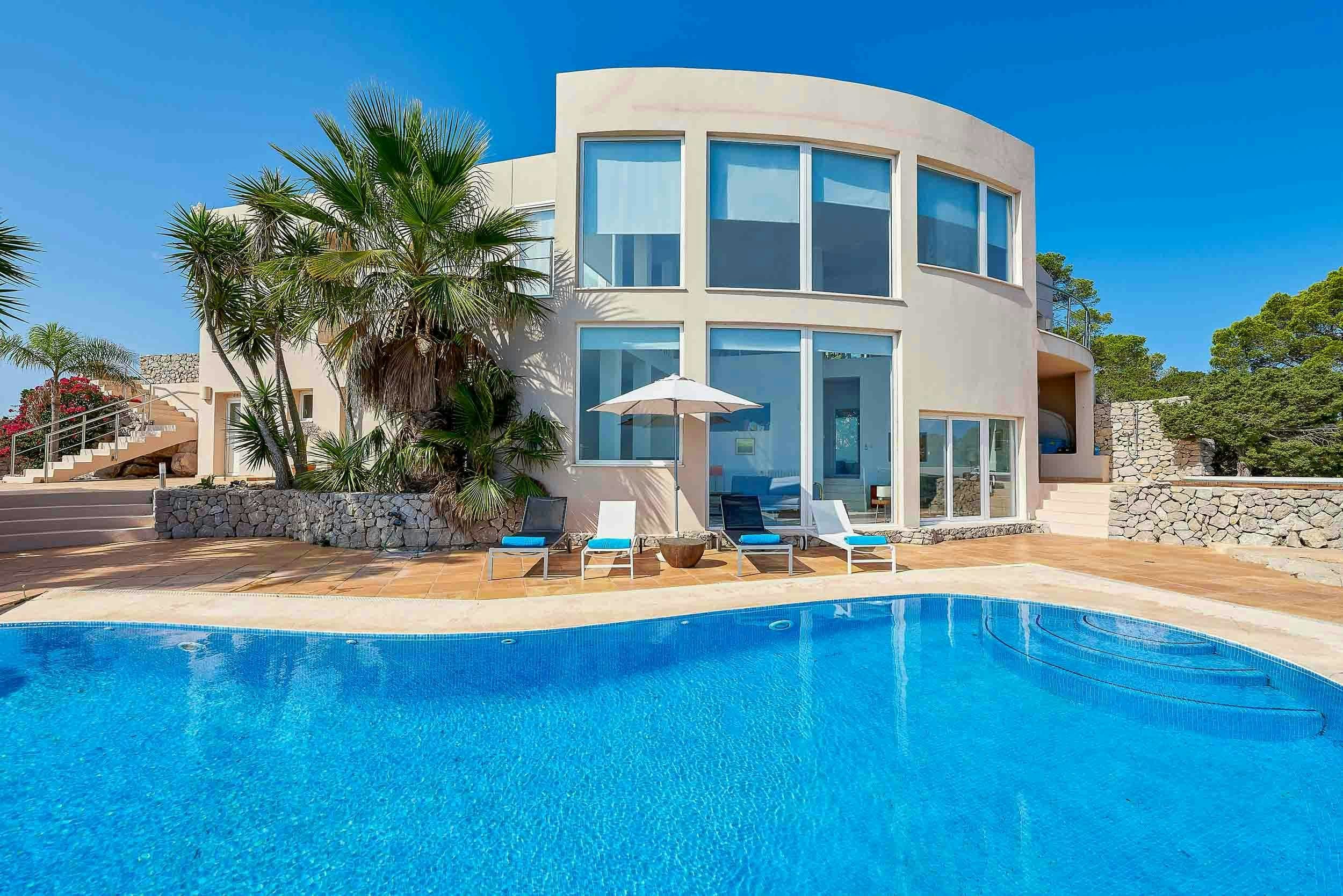 The Eyes of Benirras villa exterior with curved architecture and infinity pool, Sant Joan de Labritja, Spain